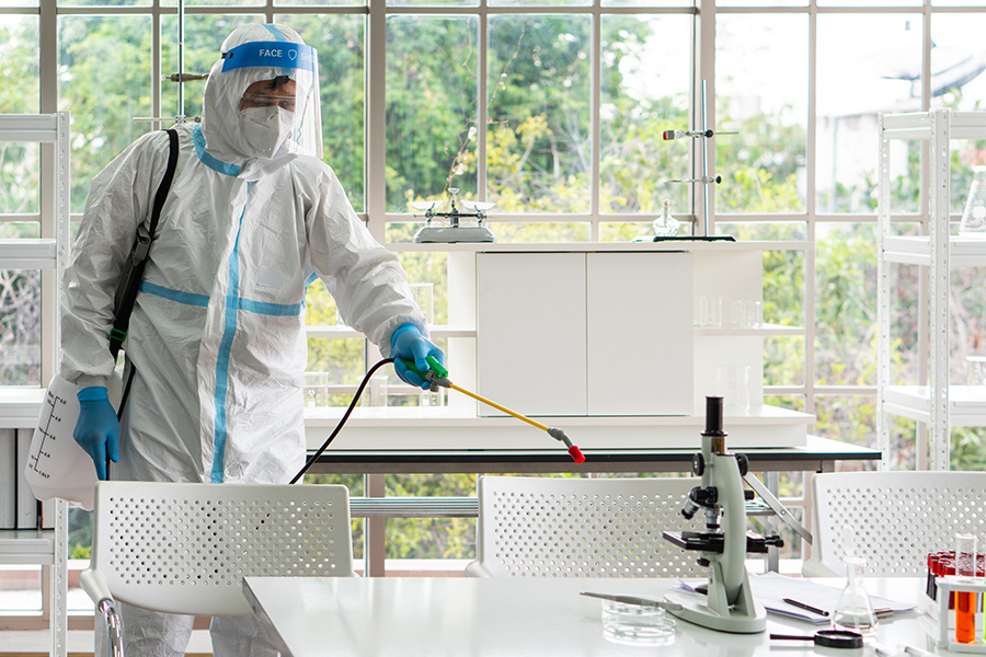 A person in full PPE performing specialist cleaning