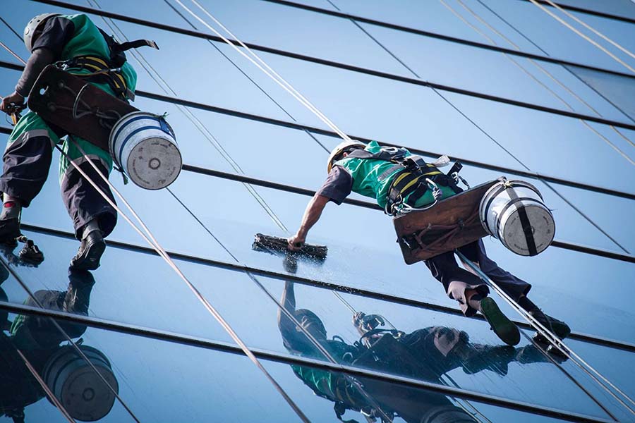 Two operators carrying out high-level cleaning on the exterior of a building